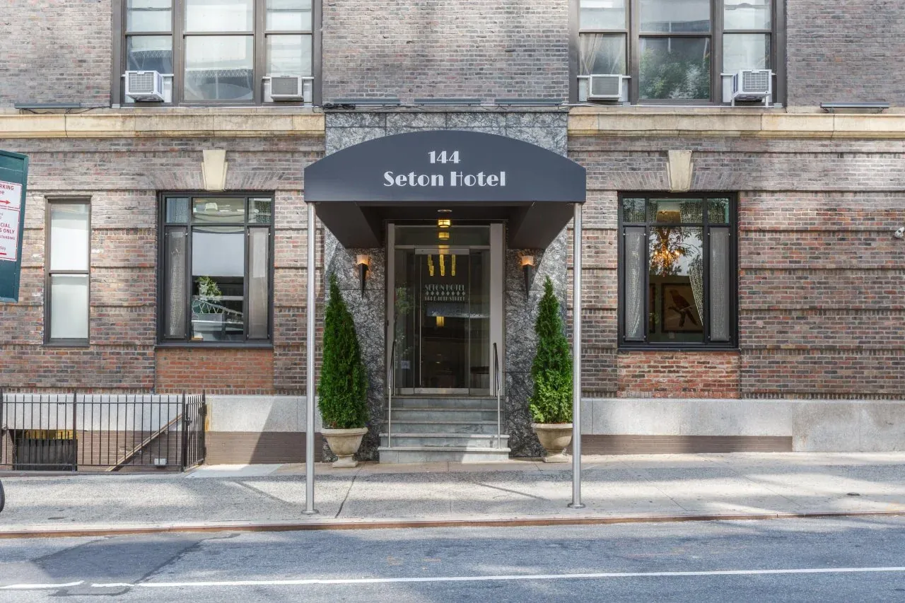 The entrance to 144 East 40th Street under its original Seton awning, seen from across the street in daylight